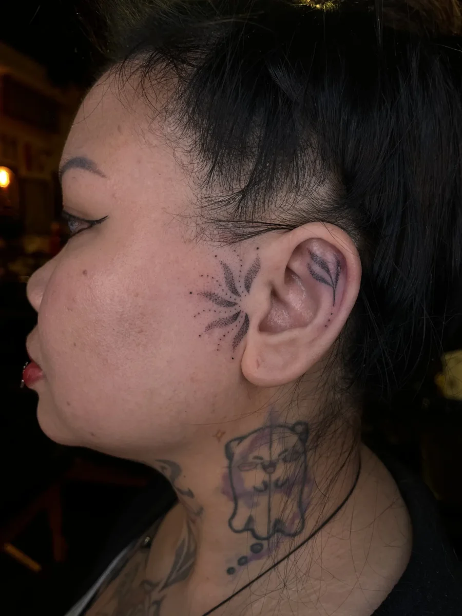 Tatouage handpoke ornemental sur le visage ou la tête, réalisé par Flori Green